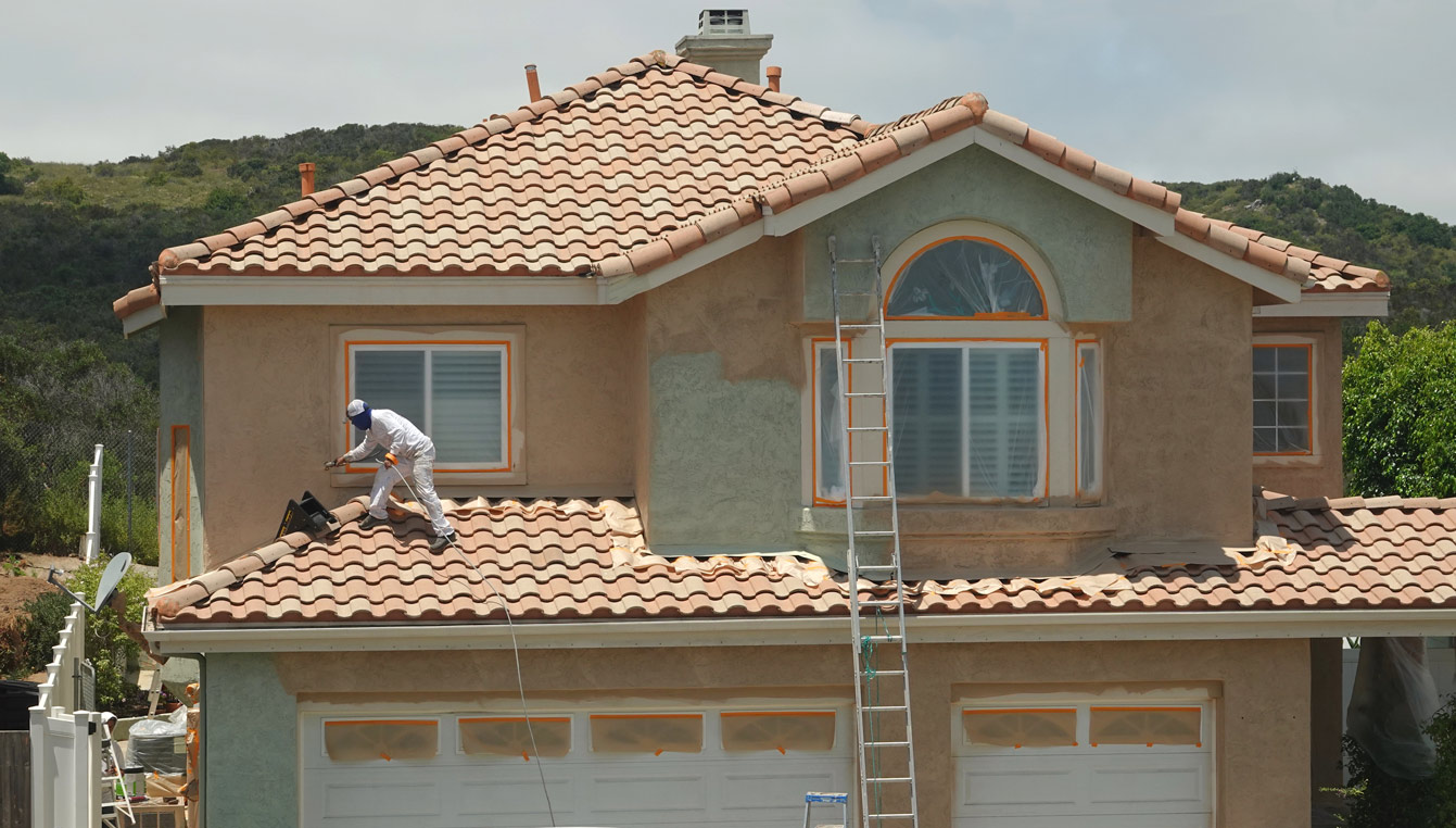 Residential house exterior being painted